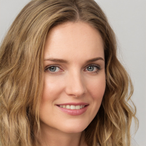 Joyful white young-adult female with long  brown hair and green eyes