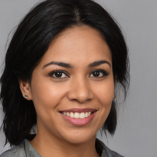 Joyful latino young-adult female with medium  black hair and brown eyes