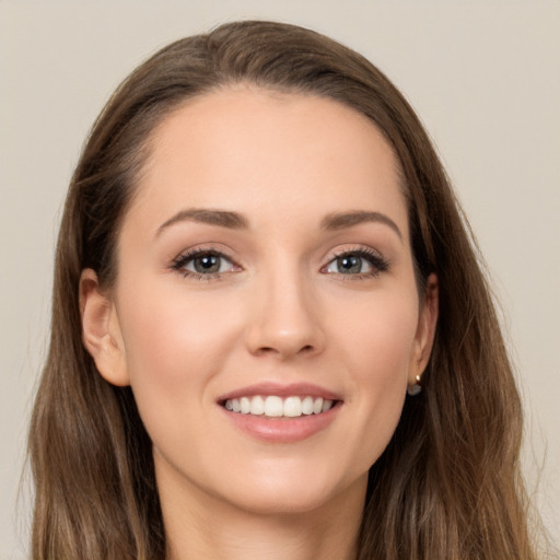 Joyful white young-adult female with long  brown hair and grey eyes