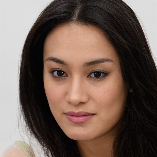 Joyful asian young-adult female with long  brown hair and brown eyes