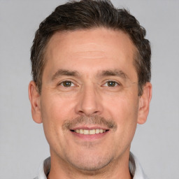 Joyful white adult male with short  brown hair and brown eyes