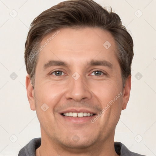 Joyful white adult male with short  brown hair and brown eyes