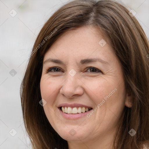 Joyful white adult female with long  brown hair and brown eyes