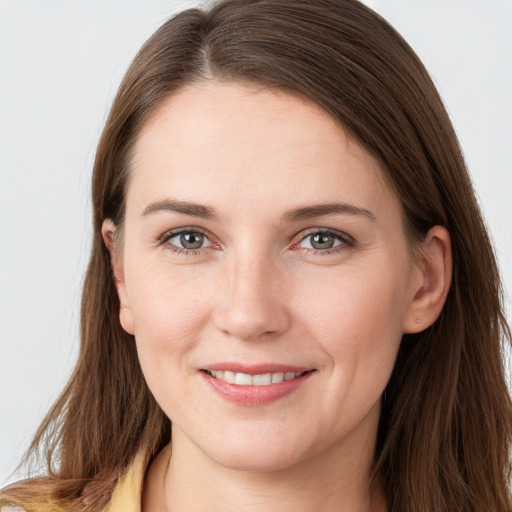 Joyful white young-adult female with long  brown hair and grey eyes