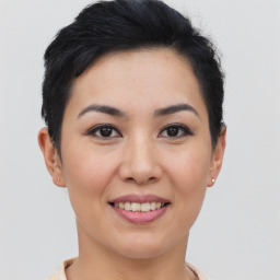 Joyful asian young-adult female with short  brown hair and brown eyes