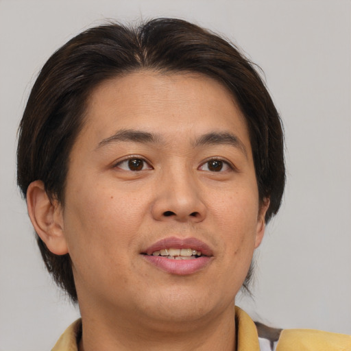 Joyful white adult male with medium  brown hair and brown eyes
