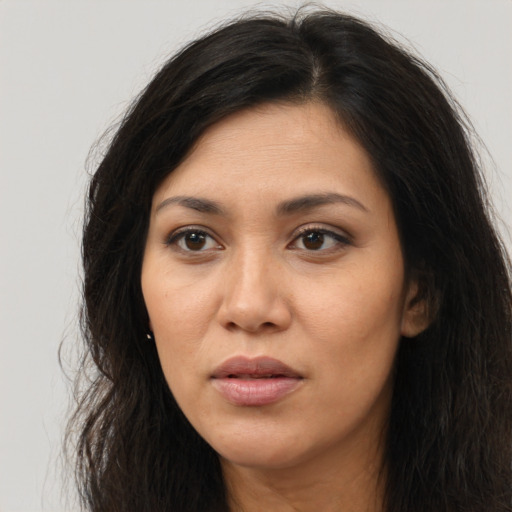 Joyful asian young-adult female with long  brown hair and brown eyes