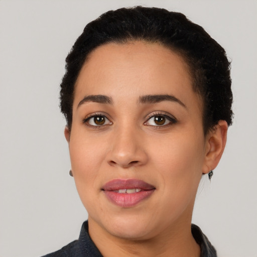 Joyful latino young-adult female with short  black hair and brown eyes