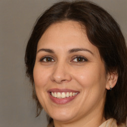 Joyful white adult female with medium  brown hair and brown eyes