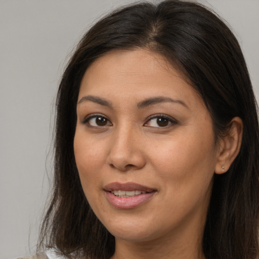 Joyful asian adult female with long  brown hair and brown eyes