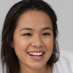 Joyful asian young-adult female with long  brown hair and brown eyes