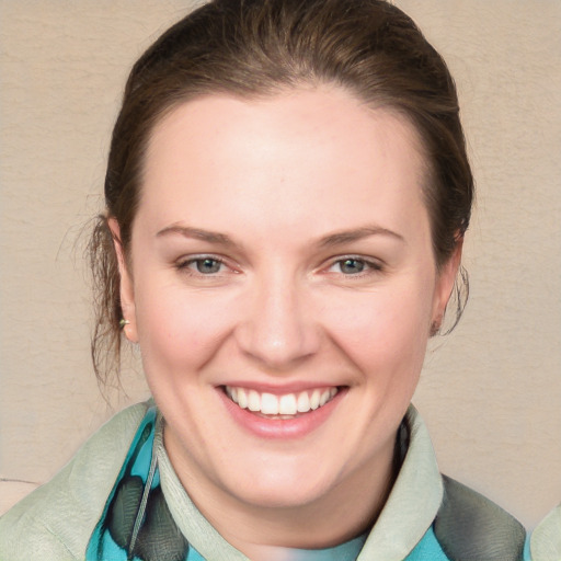 Joyful white young-adult female with medium  brown hair and blue eyes