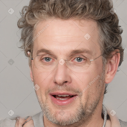 Joyful white adult male with short  brown hair and blue eyes