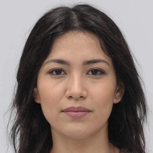 Joyful latino young-adult female with long  brown hair and brown eyes