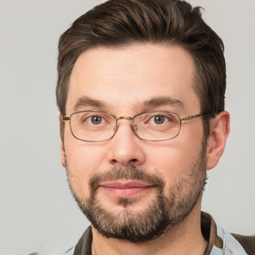 Joyful white adult male with short  brown hair and brown eyes