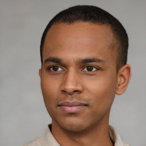 Joyful latino young-adult male with short  brown hair and brown eyes