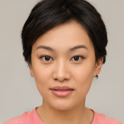 Joyful asian young-adult female with short  brown hair and brown eyes