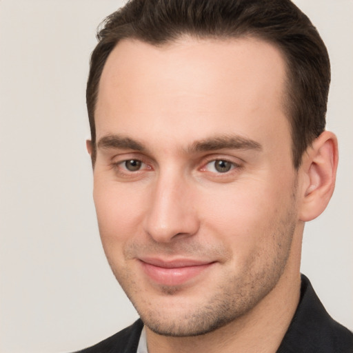 Joyful white young-adult male with short  brown hair and brown eyes