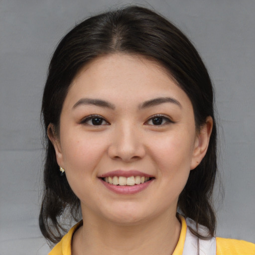 Joyful asian young-adult female with medium  brown hair and brown eyes