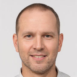 Joyful white adult male with short  brown hair and brown eyes