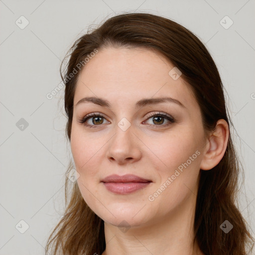 Joyful white young-adult female with long  brown hair and grey eyes