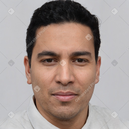 Joyful white young-adult male with short  black hair and brown eyes