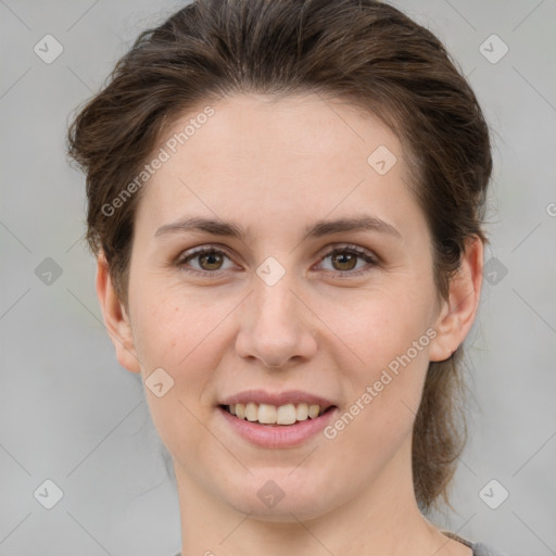 Joyful white young-adult female with medium  brown hair and grey eyes