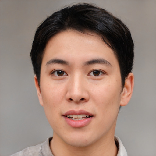 Joyful asian young-adult male with short  brown hair and brown eyes
