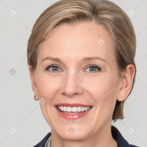 Joyful white adult female with medium  brown hair and grey eyes