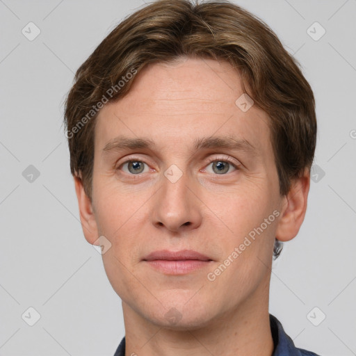 Joyful white adult male with short  brown hair and grey eyes