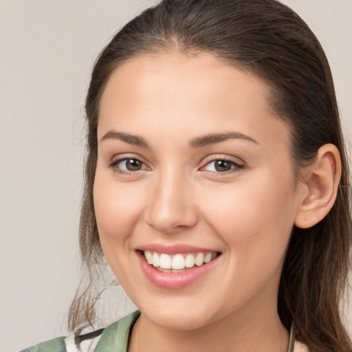 Joyful white young-adult female with medium  brown hair and brown eyes