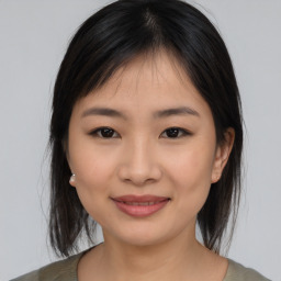 Joyful asian young-adult female with medium  black hair and brown eyes