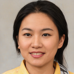 Joyful asian young-adult female with medium  brown hair and brown eyes