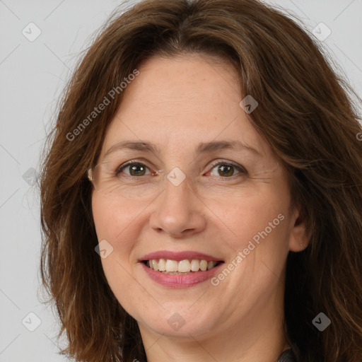 Joyful white adult female with long  brown hair and brown eyes