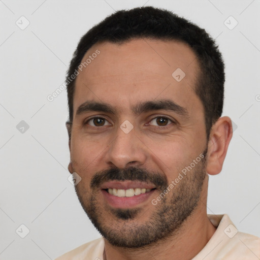 Joyful white young-adult male with short  black hair and brown eyes