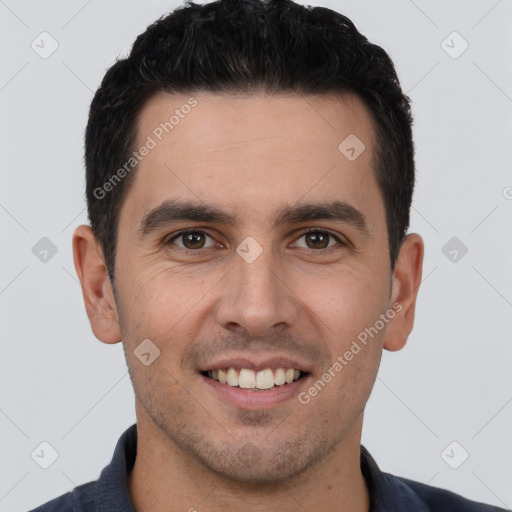 Joyful white young-adult male with short  black hair and brown eyes