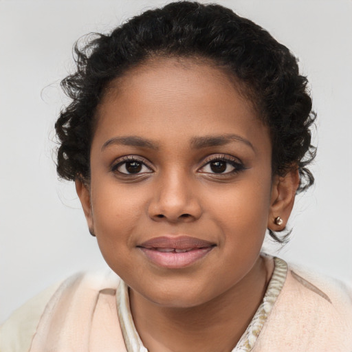 Joyful black child female with long  brown hair and brown eyes