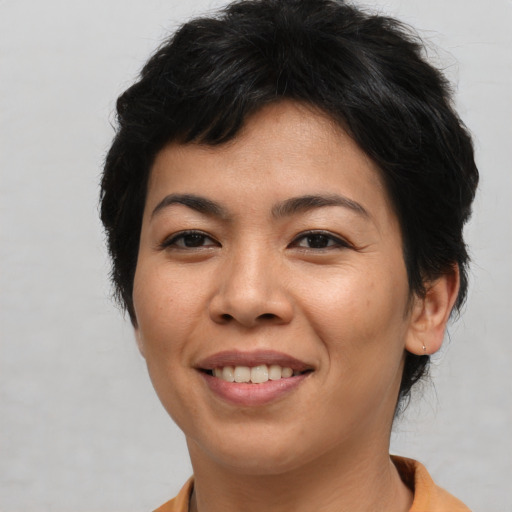 Joyful asian young-adult female with short  brown hair and brown eyes