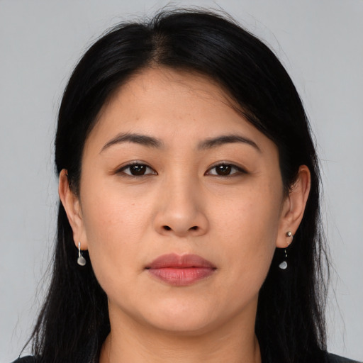Joyful asian young-adult female with long  brown hair and brown eyes