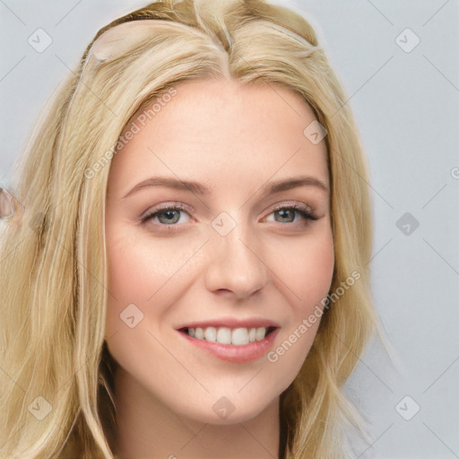 Joyful white young-adult female with long  brown hair and blue eyes