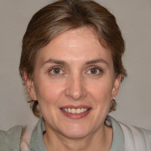 Joyful white adult female with medium  brown hair and blue eyes