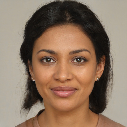 Joyful black young-adult female with medium  brown hair and brown eyes