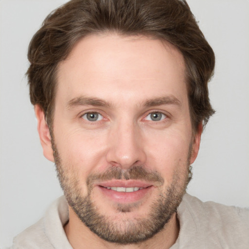 Joyful white adult male with short  brown hair and brown eyes