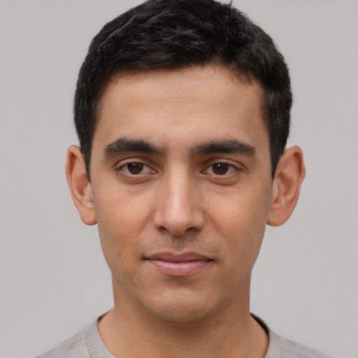 Joyful white young-adult male with short  black hair and brown eyes