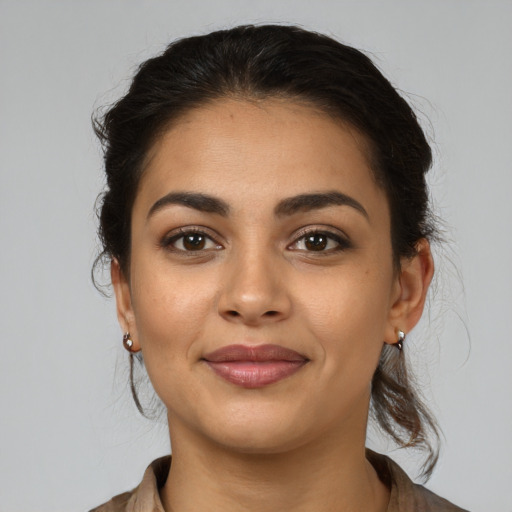 Joyful latino young-adult female with medium  brown hair and brown eyes