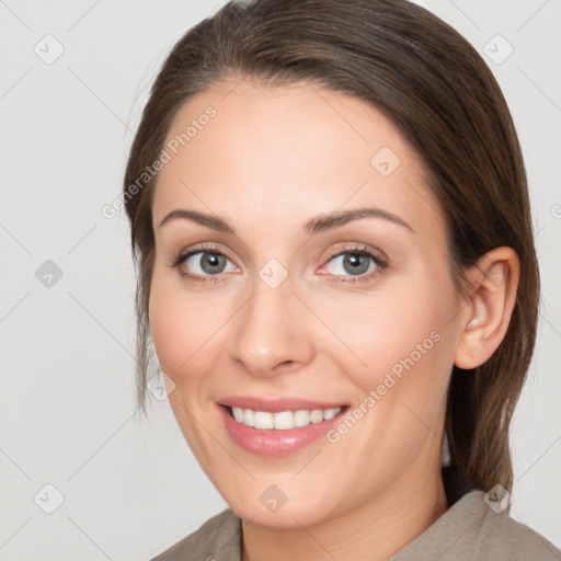 Joyful white young-adult female with medium  brown hair and grey eyes