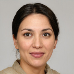 Joyful white adult female with medium  brown hair and brown eyes