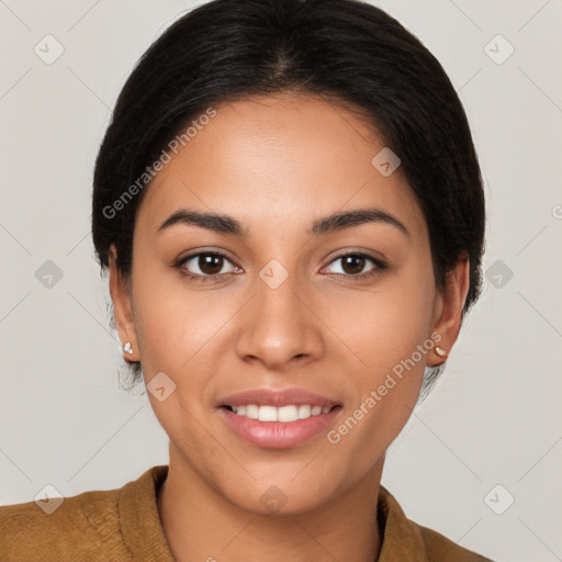 Joyful latino young-adult female with short  brown hair and brown eyes