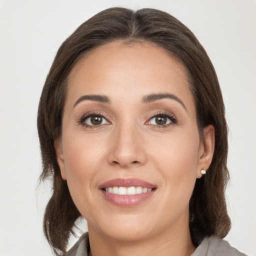 Joyful white young-adult female with medium  brown hair and brown eyes