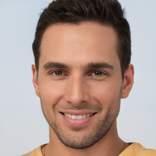 Joyful white young-adult male with short  brown hair and brown eyes